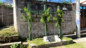 These are crosses for a neighborhood. Crosses have a dual meaning in Mayan culture -- both the Christian cross and a symbol for the ceiba tree, connecting the underworld, terrestrial world, and sky. The green color represents fertility. You see these crosses everywhere.