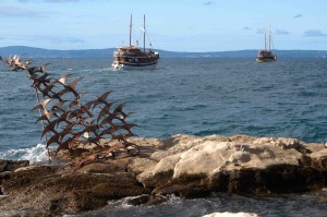 Seaside sculpture and party boats. Some of these boats go out for multiple day cruises and are expressly designed for young folks -- lots of booze, bunk rooms down below, cruising between the islands, and cheap! 