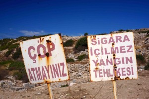 After tromping around the bush for a while, I asked Dogan if there were any poisonous snakes around. "Sure," he said, "and lots of scorpions too!" So while I don't remember the translation of these signs, it should say "Beware of snakes and scorpions!"