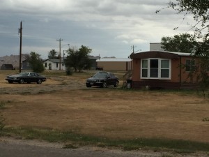 Interior must be an up and coming place. Notice the two Jags outside this mobile home!